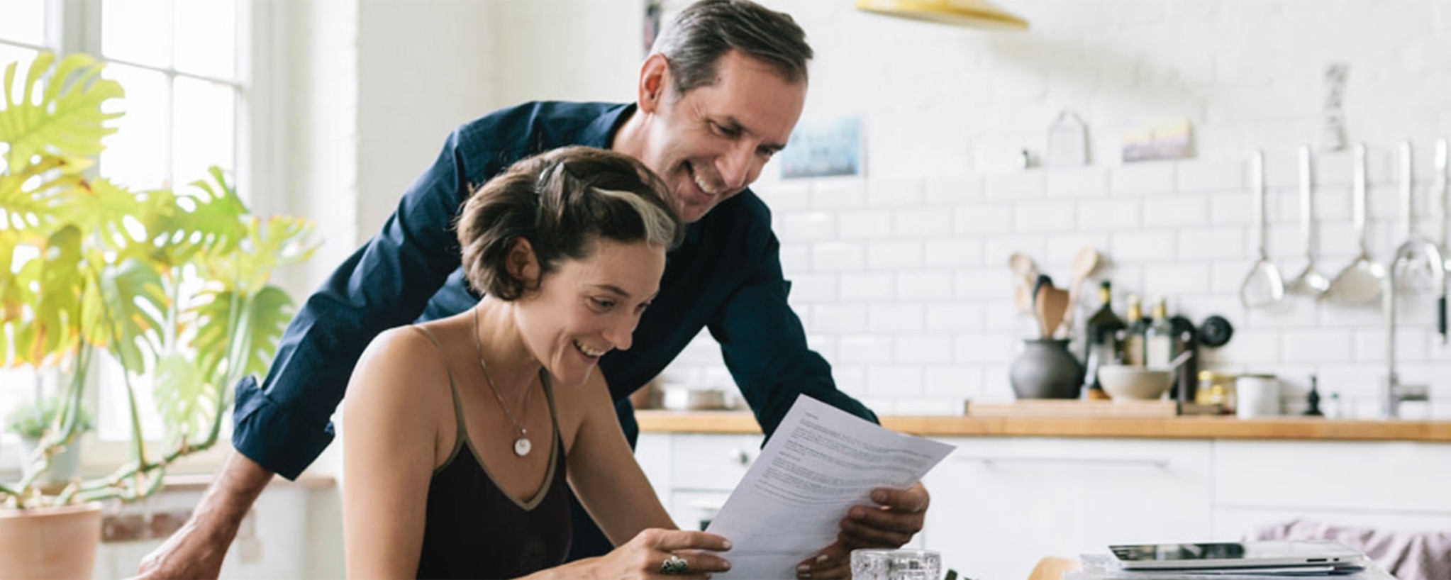 A man and a woman review the terms of a certificate of deposit (CD) to decide if they want to invest in it.