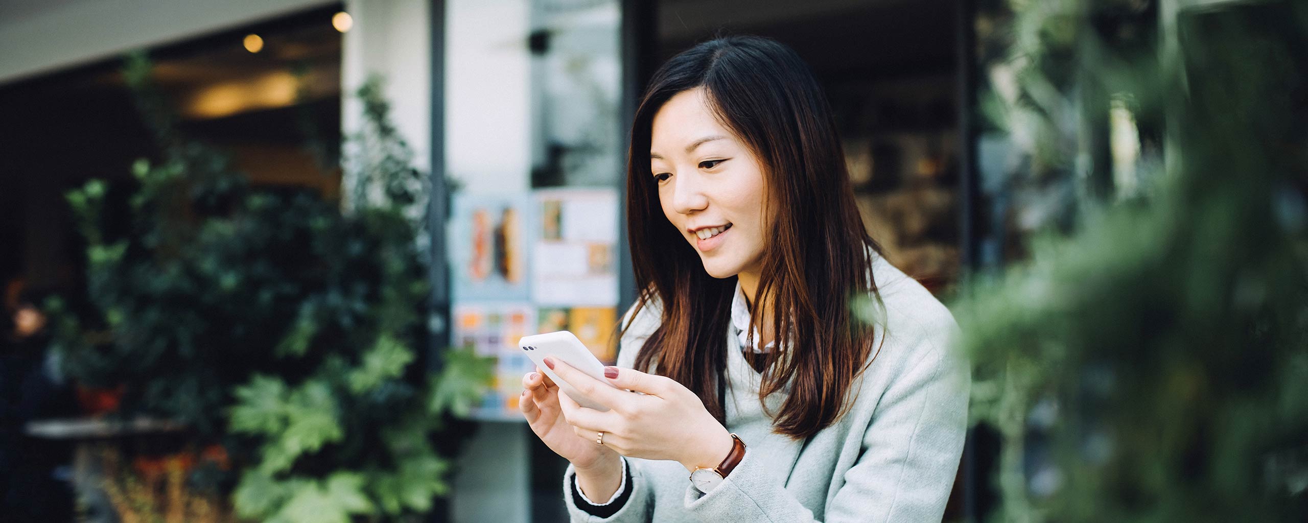 A woman safely does her banking online from her smartphone.