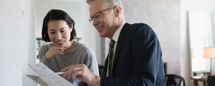 A financial adviser discusses brokered certificates of deposit (CDs) with a woman interested in investing.