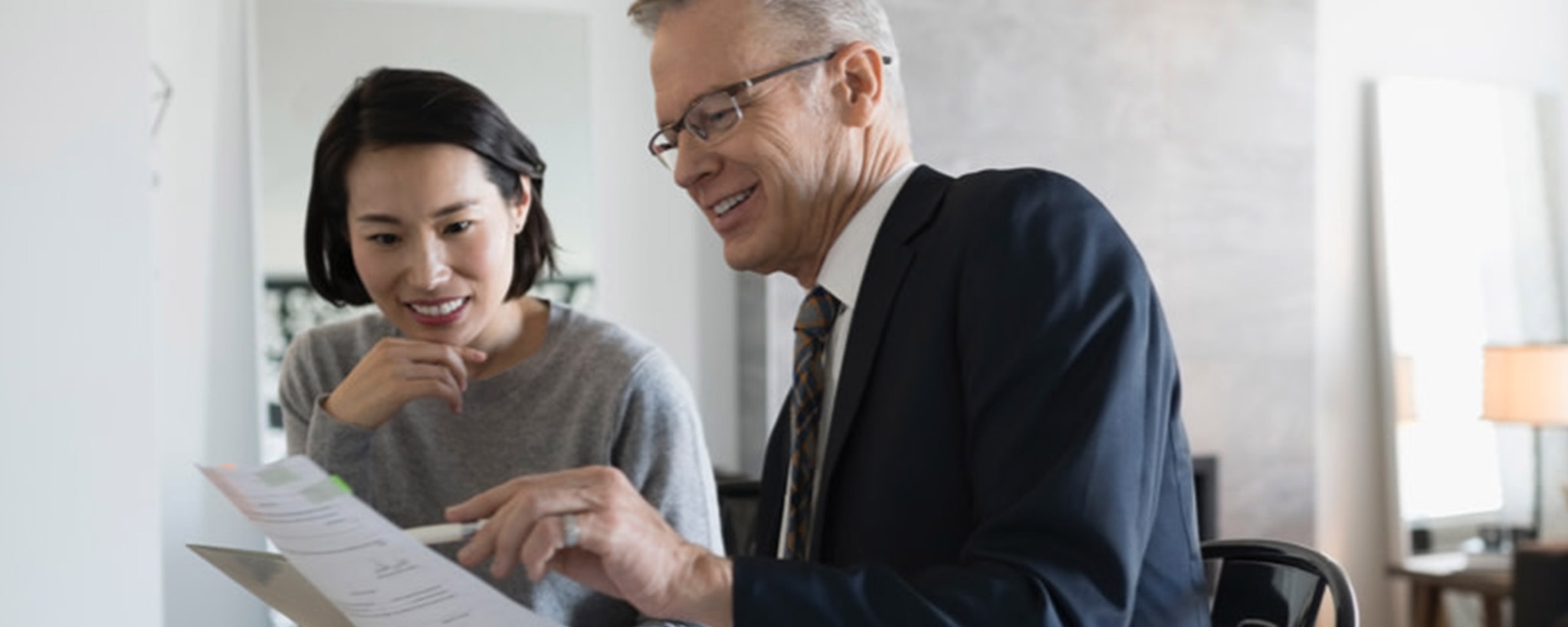 A financial adviser discusses brokered certificates of deposit (CDs) with a woman interested in investing.