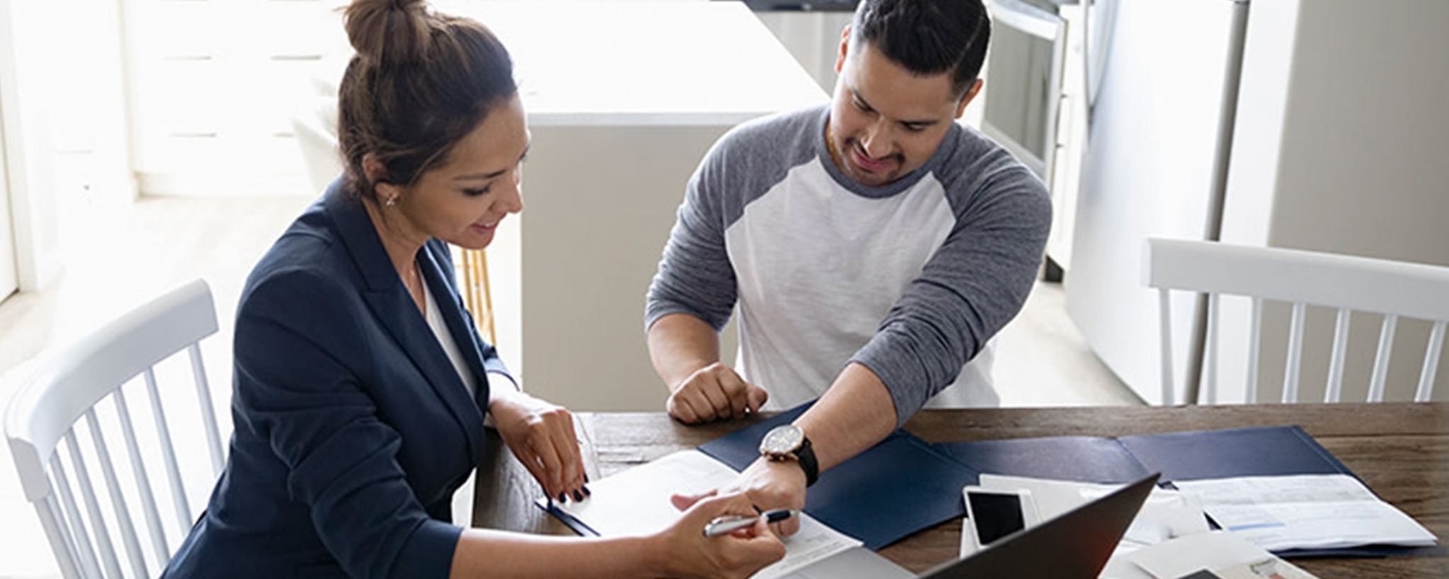 A woman explains to a man why opening a high-yield savings account could be beneficial to him.
