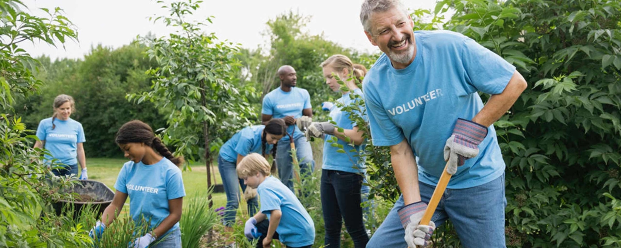 Members of a 501(c)(3) charitable organization do some gardening to give back to the community.