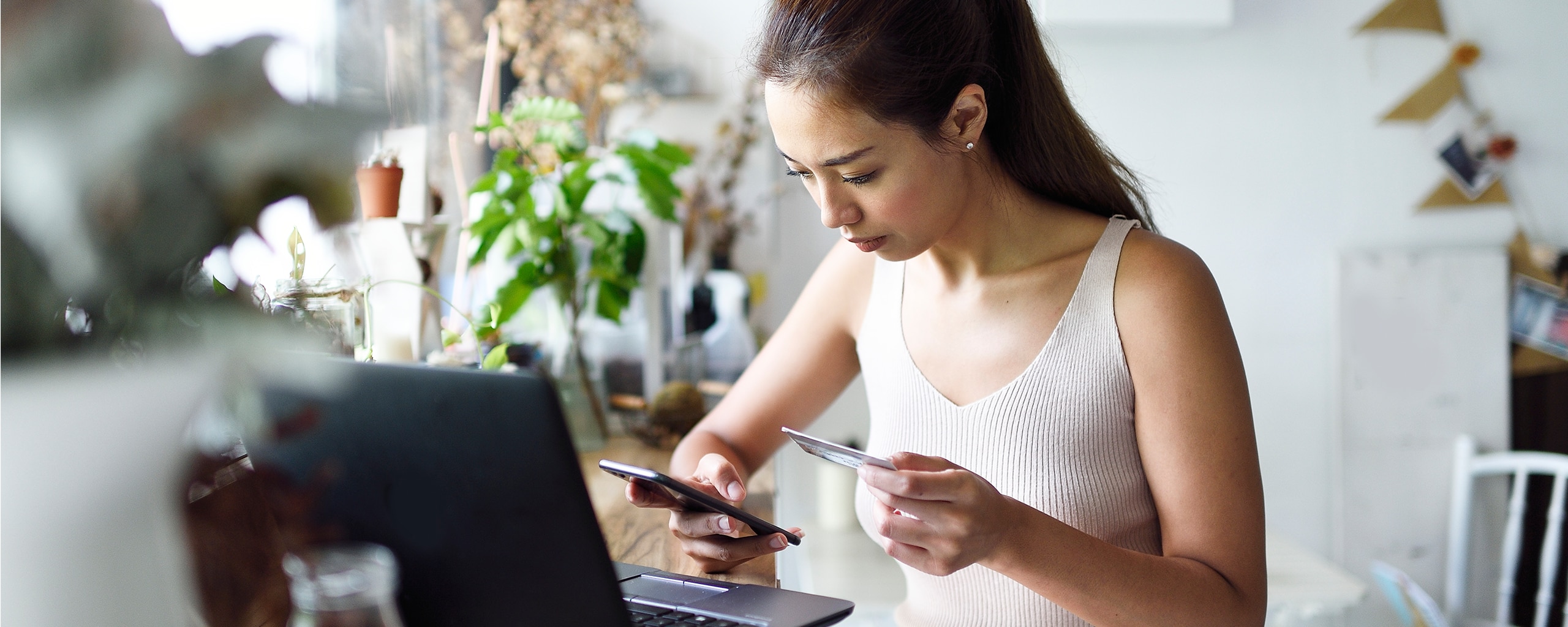 Woman entering credit card data into her phone