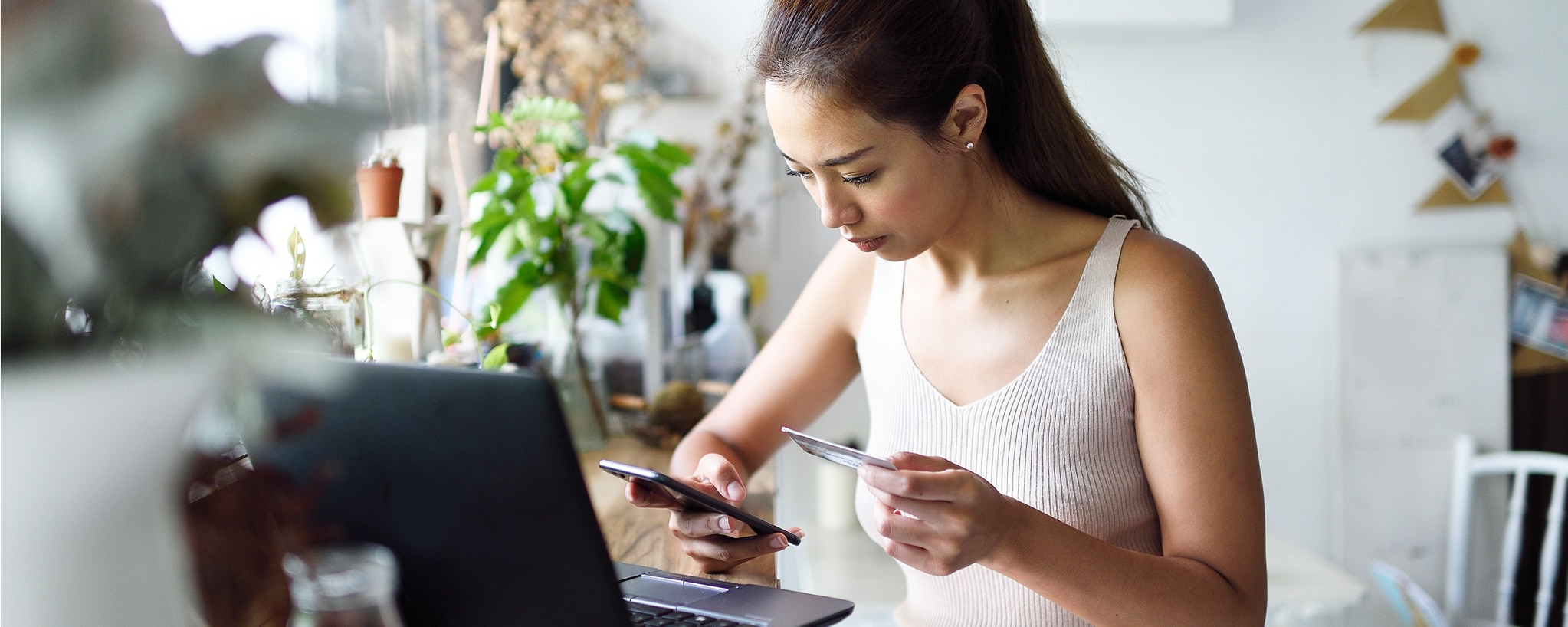 Woman entering credit card data into her phone