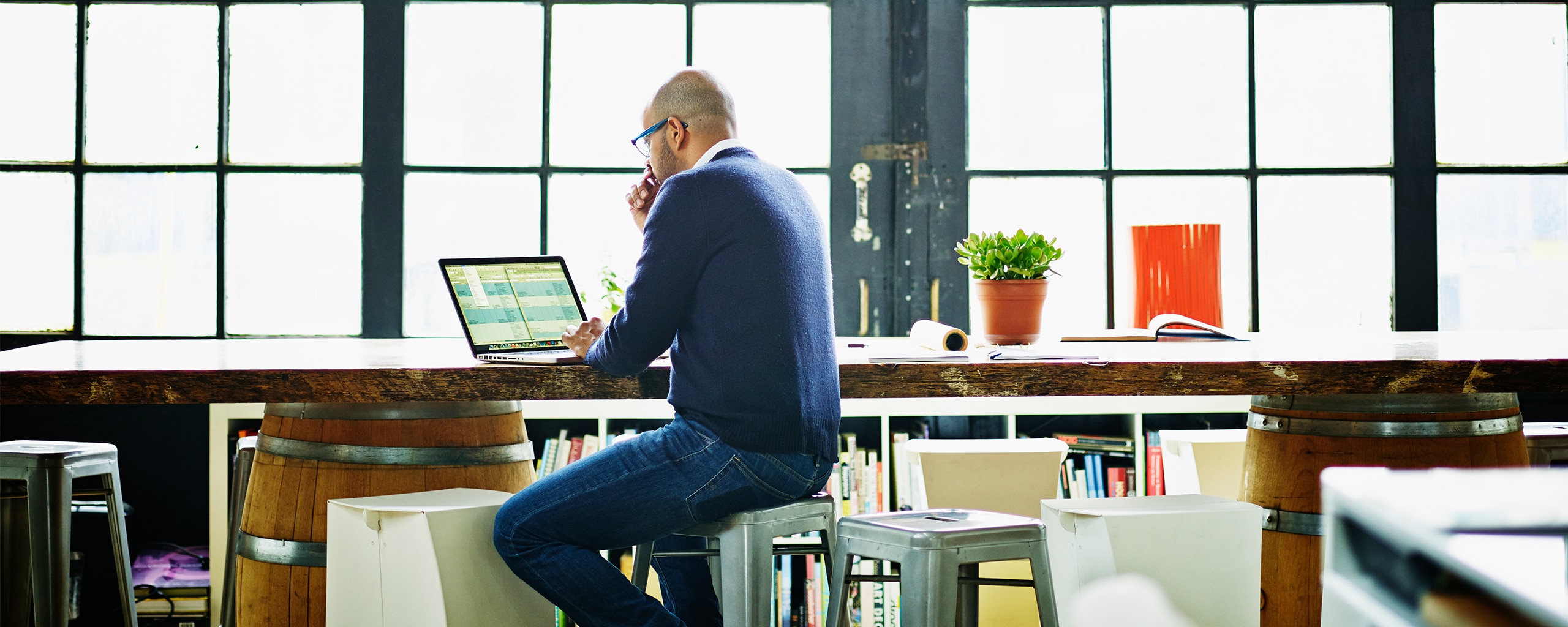 Man with glasses looking at laptop