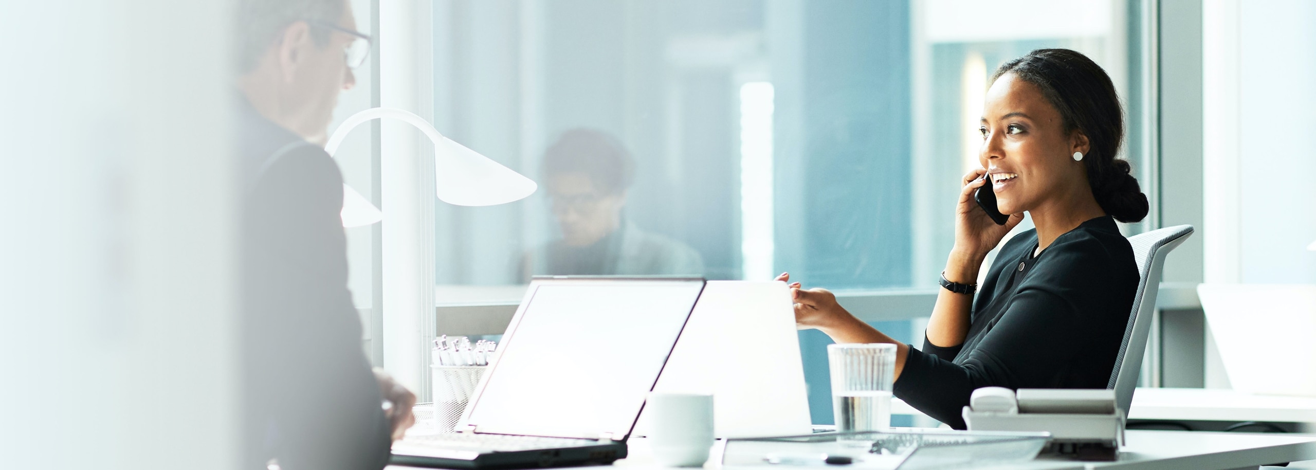 Image of woman in the office discussing payment solutions on the phone