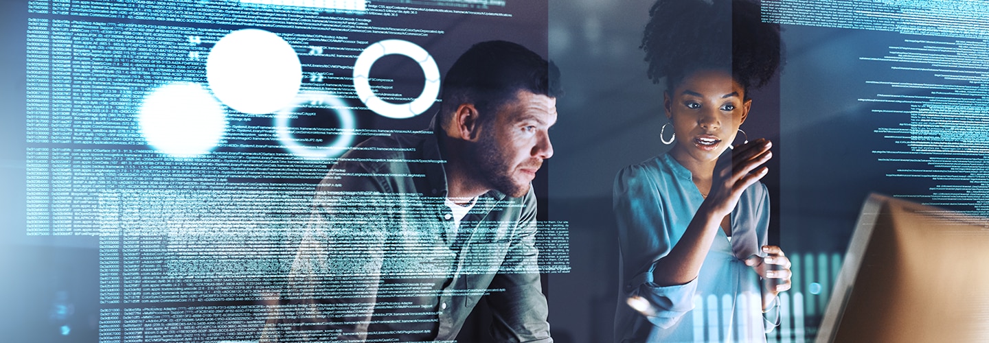 Image of man and woman looking at data on technology screens
