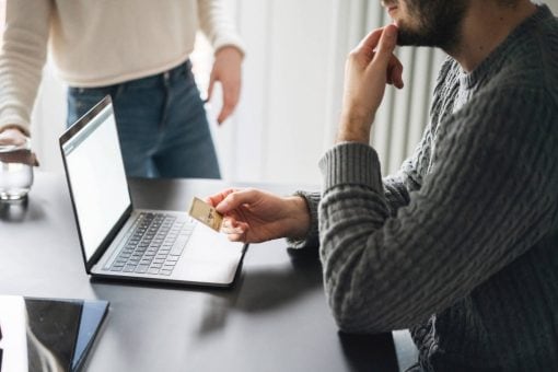 Man shops online using a credit card.