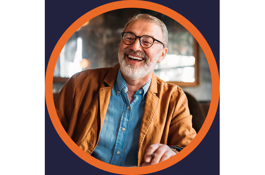 A smiling man with a beard and glasses