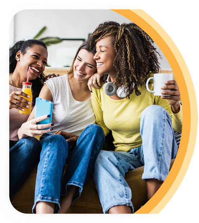Three women friends smiling and chatting with each other