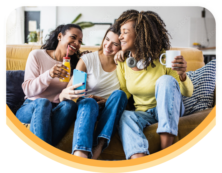 Three women friends smiling and chatting with each other