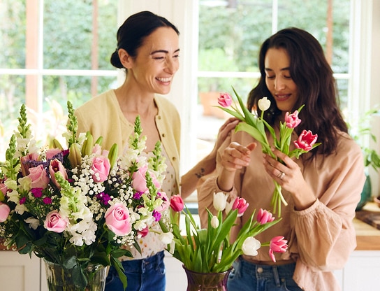 Two people organizing a bouquet