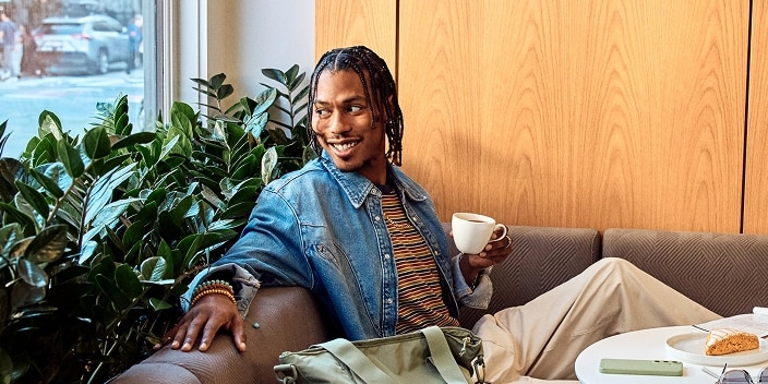 Person enjoying coffee and pastry
