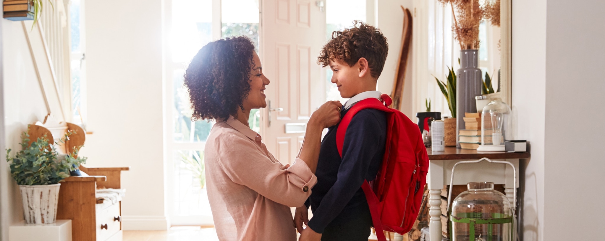 Mother preparing son for his first day of school
