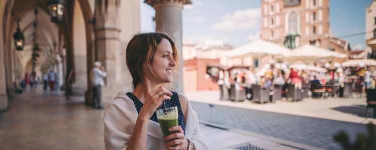Female student relaxing at an outdoor café while studying abroad.