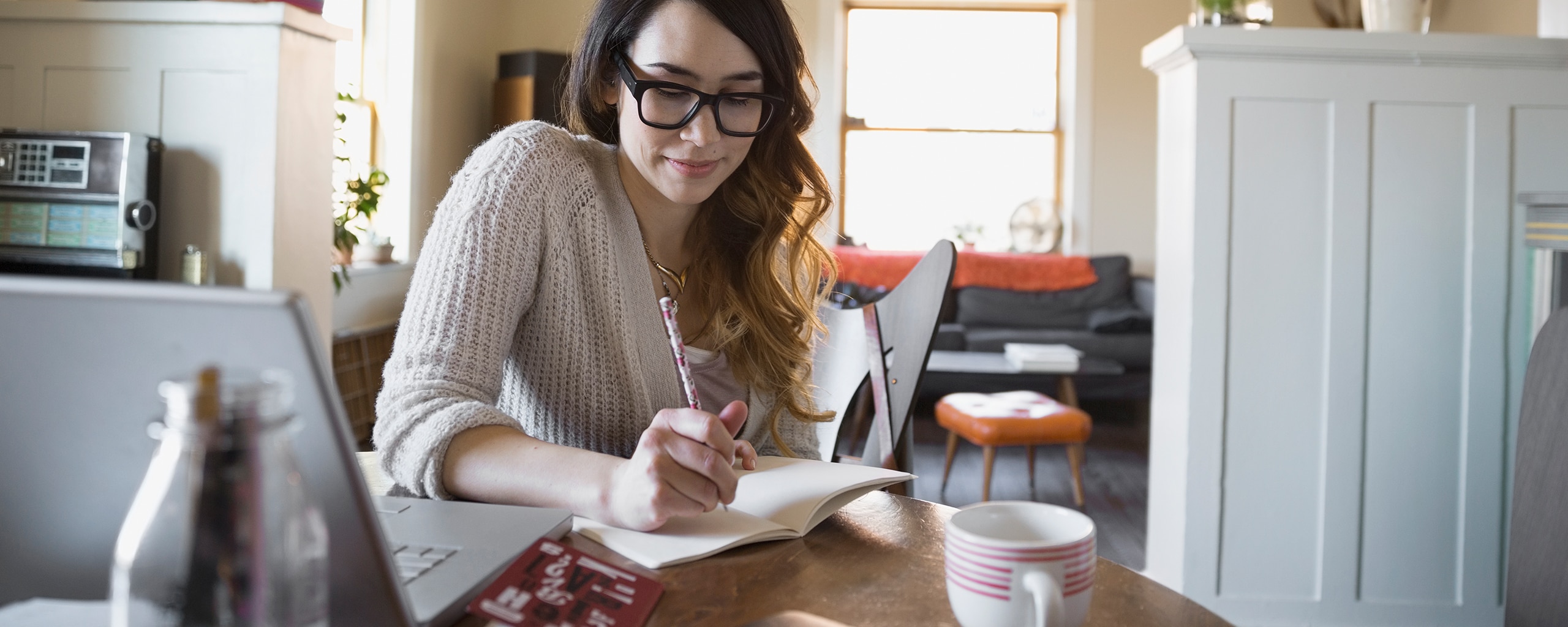 As part of a process to build credit, a woman compares her monthly credit card statement with the budget she created.