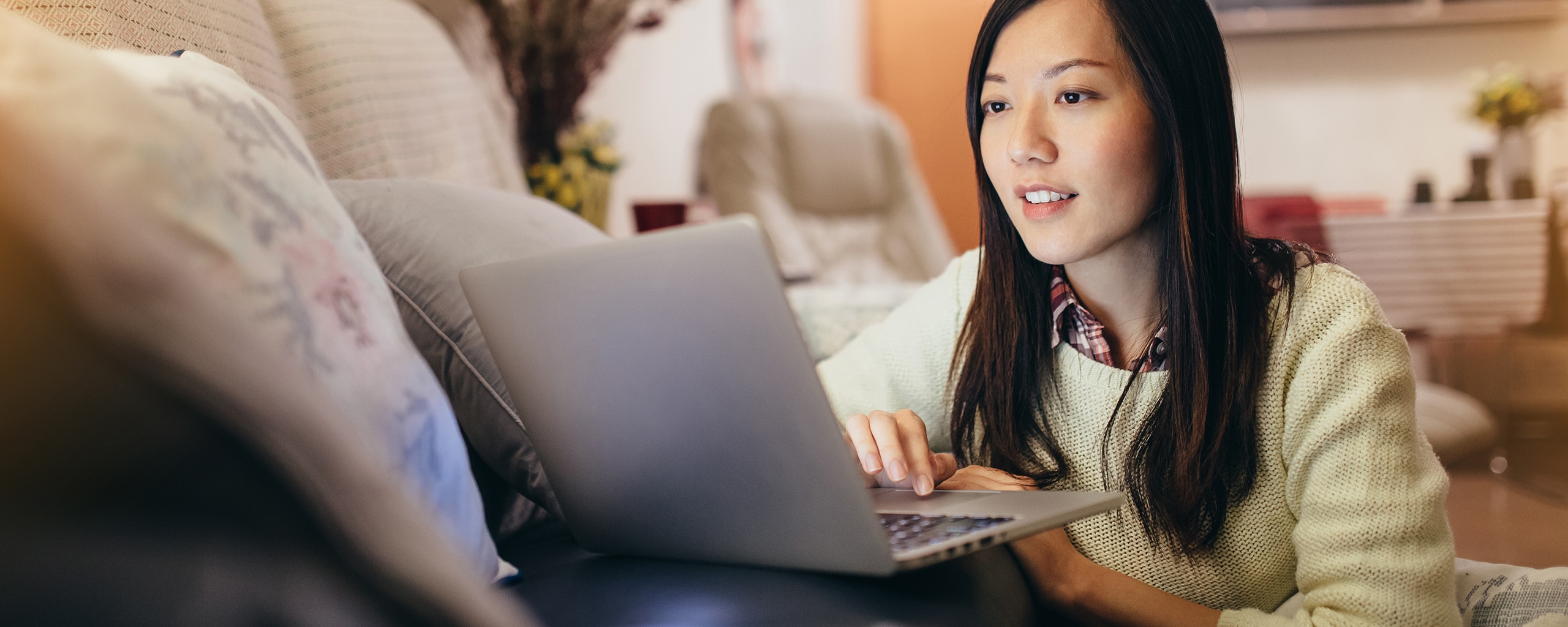 A woman takes time at home to explore Capital One’s credit policies.
