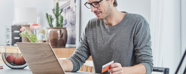 A man uses his laptop to shop securely online.