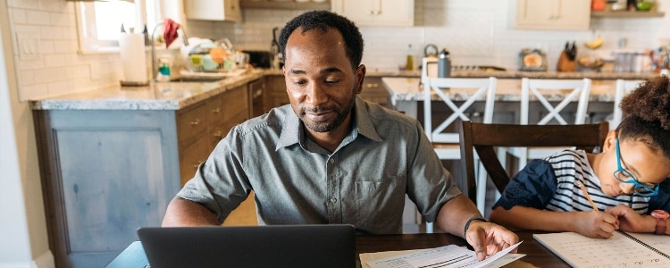 A person files their taxes on their laptop.