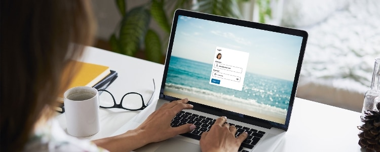 A person types in their password on a laptop.
