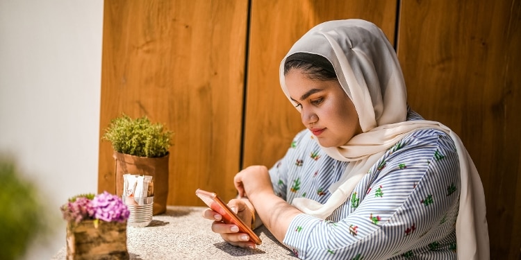 A person checks their FICO® Score 8 credit score on their phone.