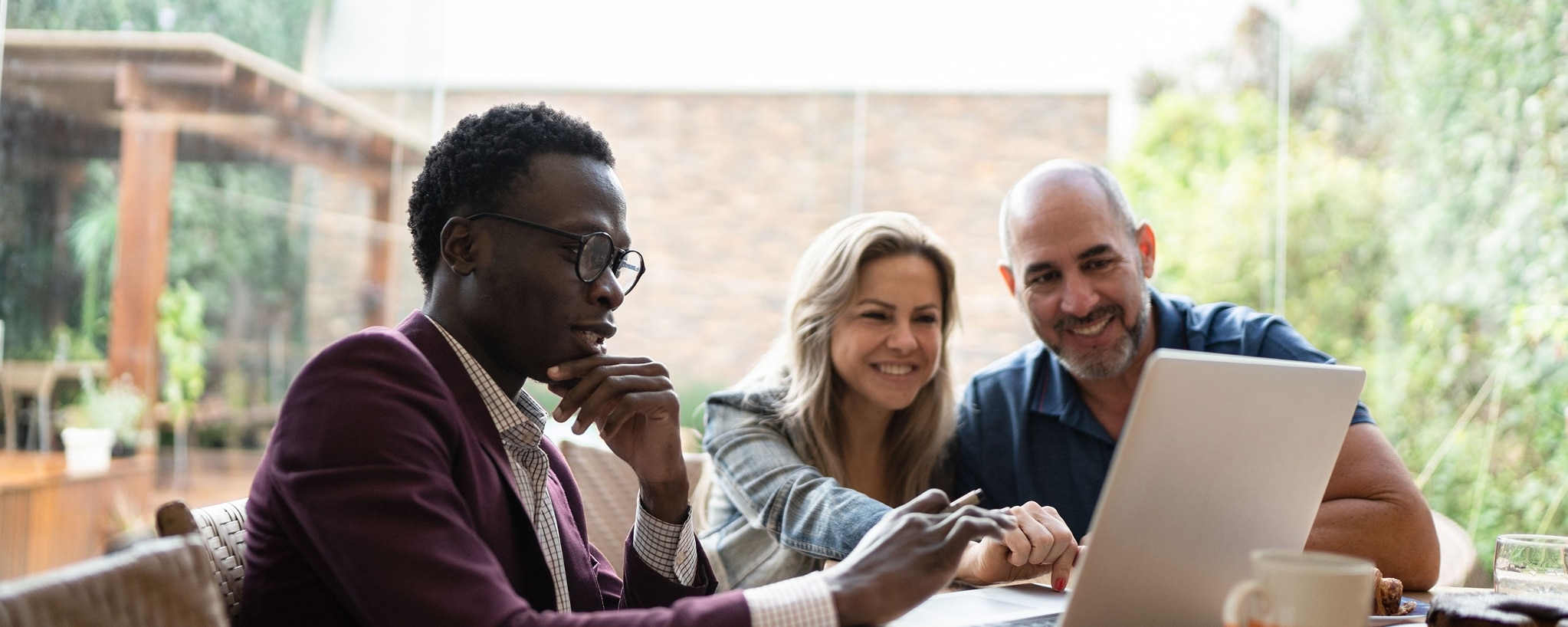 A couple and their real estate agent submit an earnest money deposit.&nbsp;