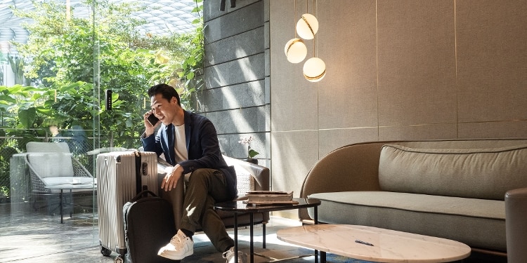 A passenger waits for his flight in an airport lounge.