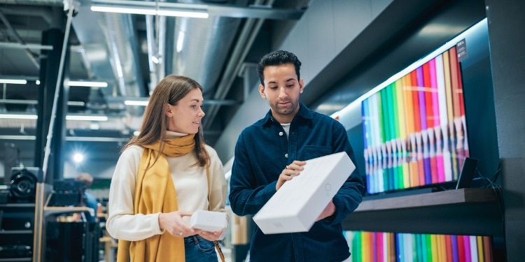 Two people shopping at an electronics store.