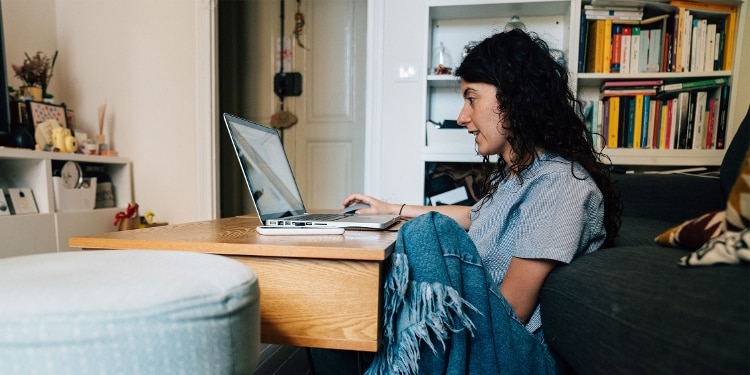 A person looking at the differences between VantageScore and FICO on their laptop.