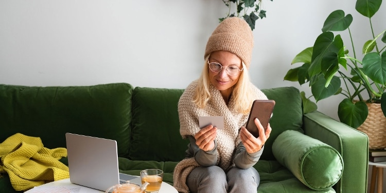 A person pays for something on their phone using a credit card.