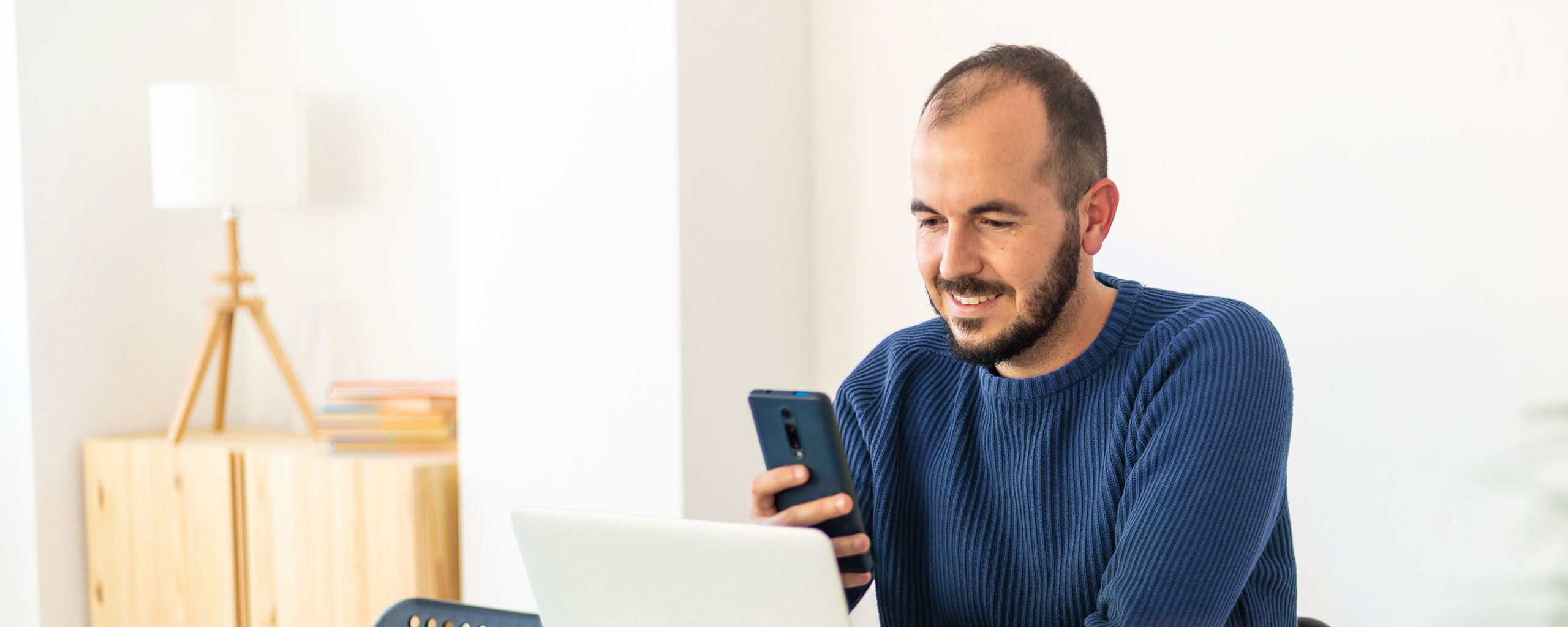 A person monitors their credit and looks at their credit scores on their cellphone.