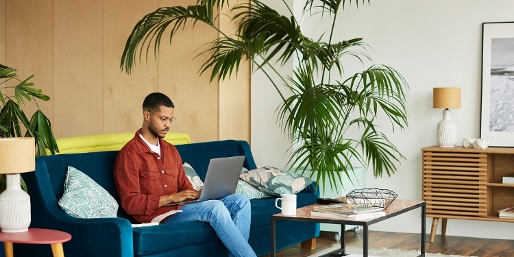 A photo of a person viewing their credit card balance on their laptop.