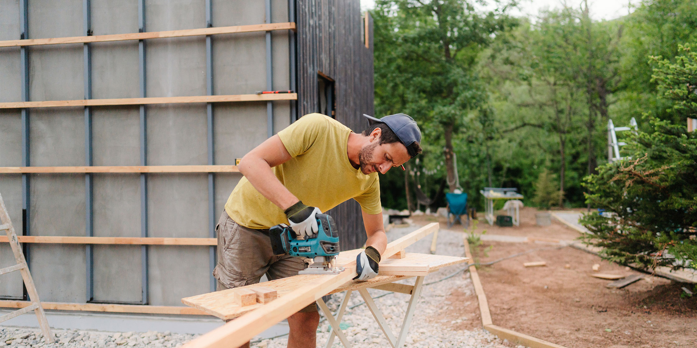 A person sawing through a piece of wood.