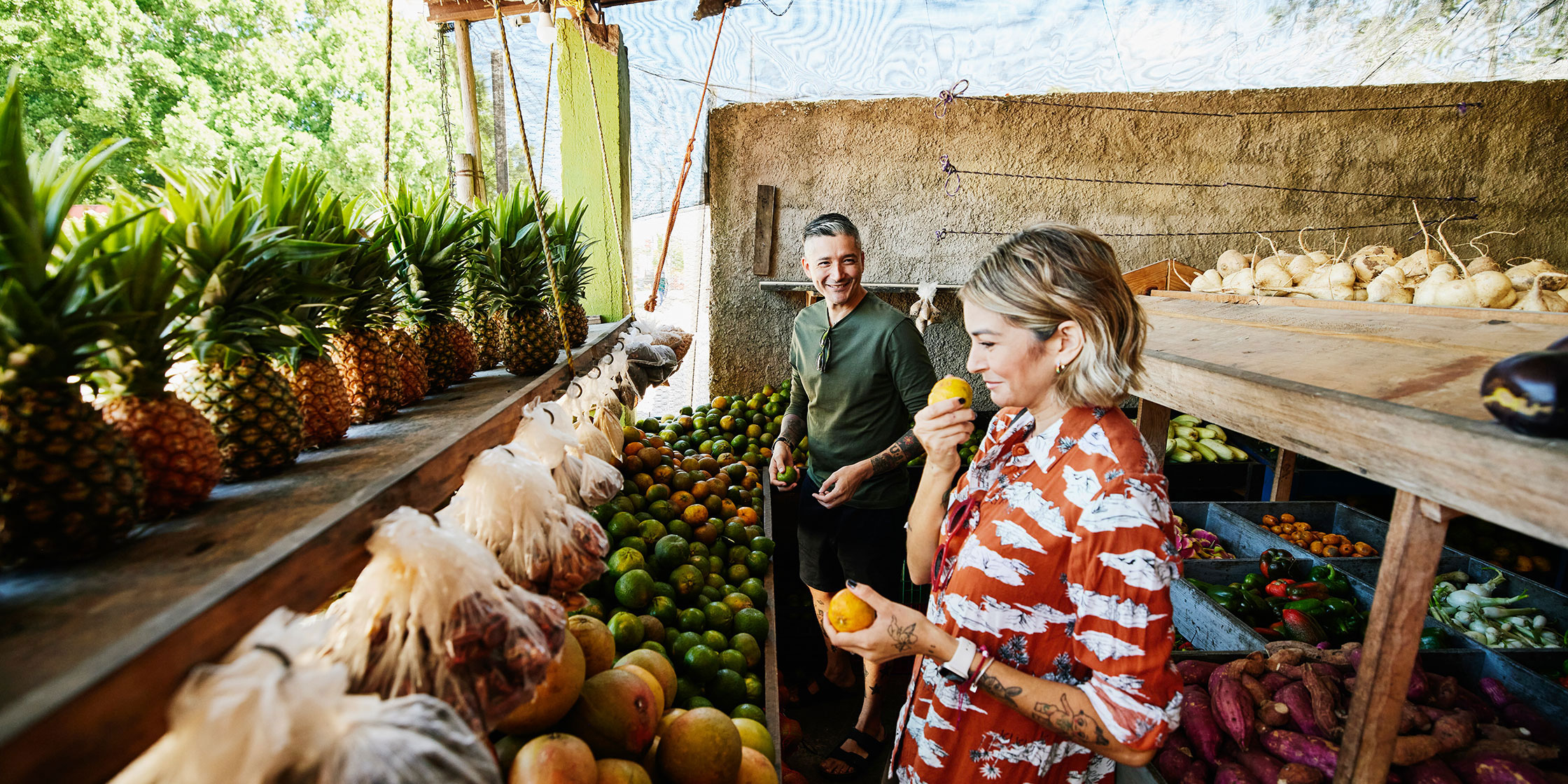 A couple shopping at a farm stand.