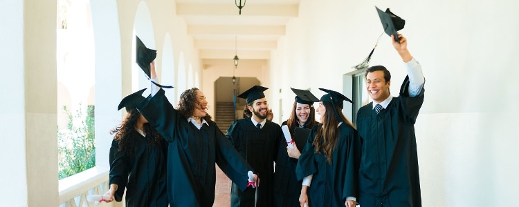 Recent graduates celebrate earning their college degrees.