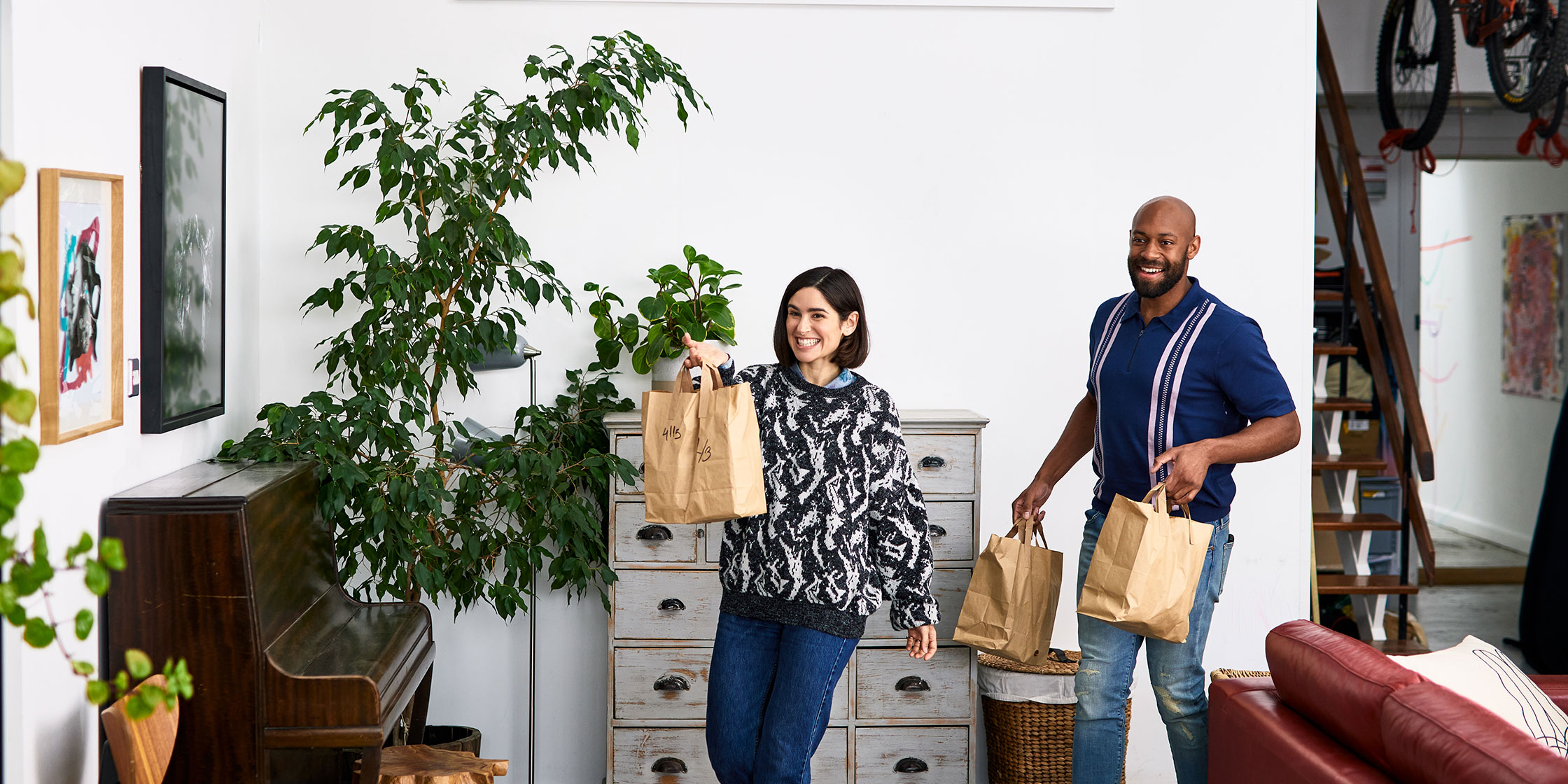 A couple returns home, happy that they earned three percent cash back by using their Capital One SavorOne credit card to purchase groceries and takeout.