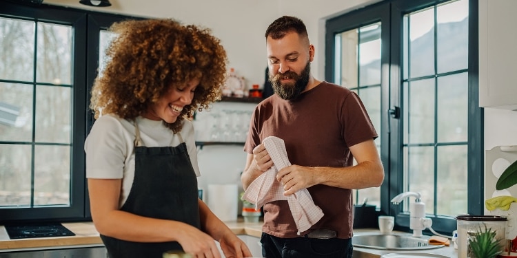 Two people cooking together in a kitchen.