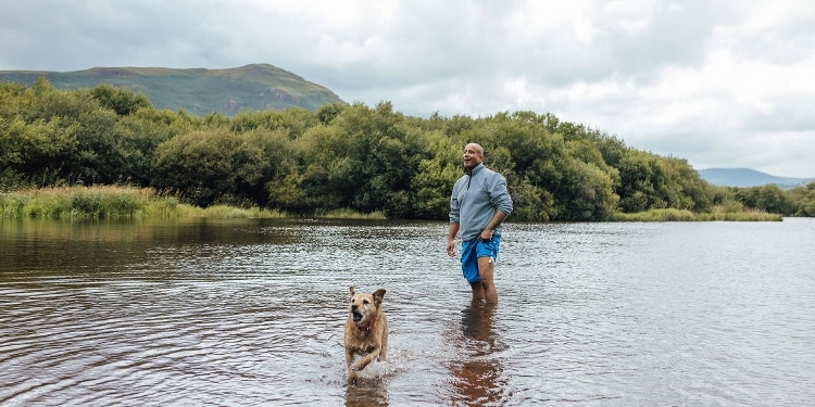 Man traveling with dog outdoors