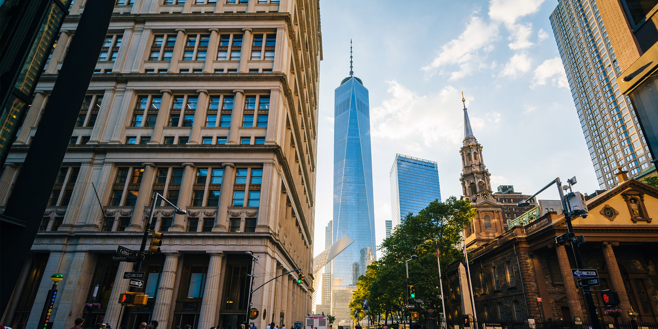 The intersection of Fulton Street and Broadway in downtown Manhattan, with the World Trade Center in the background.