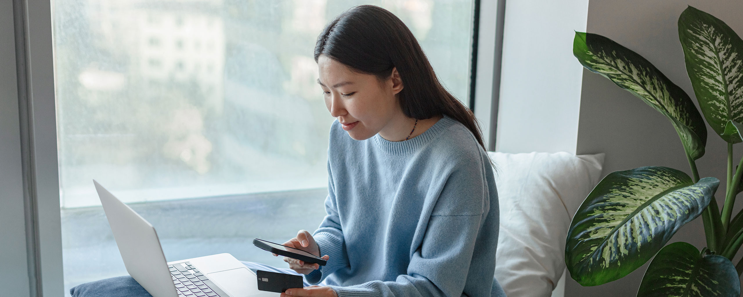 A person makes a payment with a card they applied for from a credit card issuer.