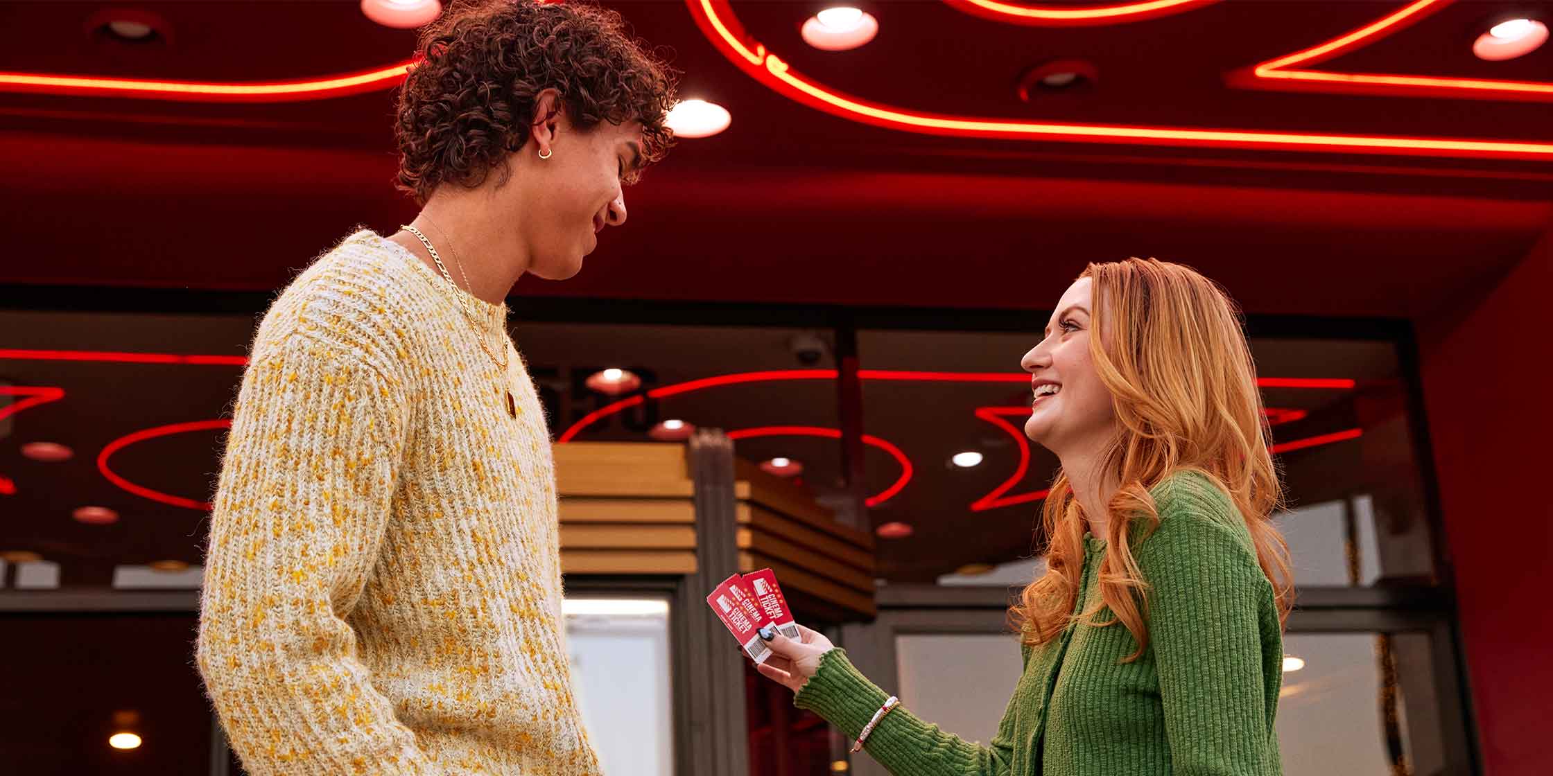 Couple shows off movie tickets they bought using a student discount.