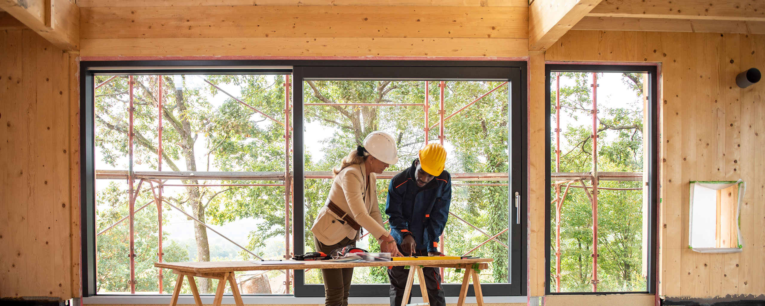 An architect and construction worker look at plans.