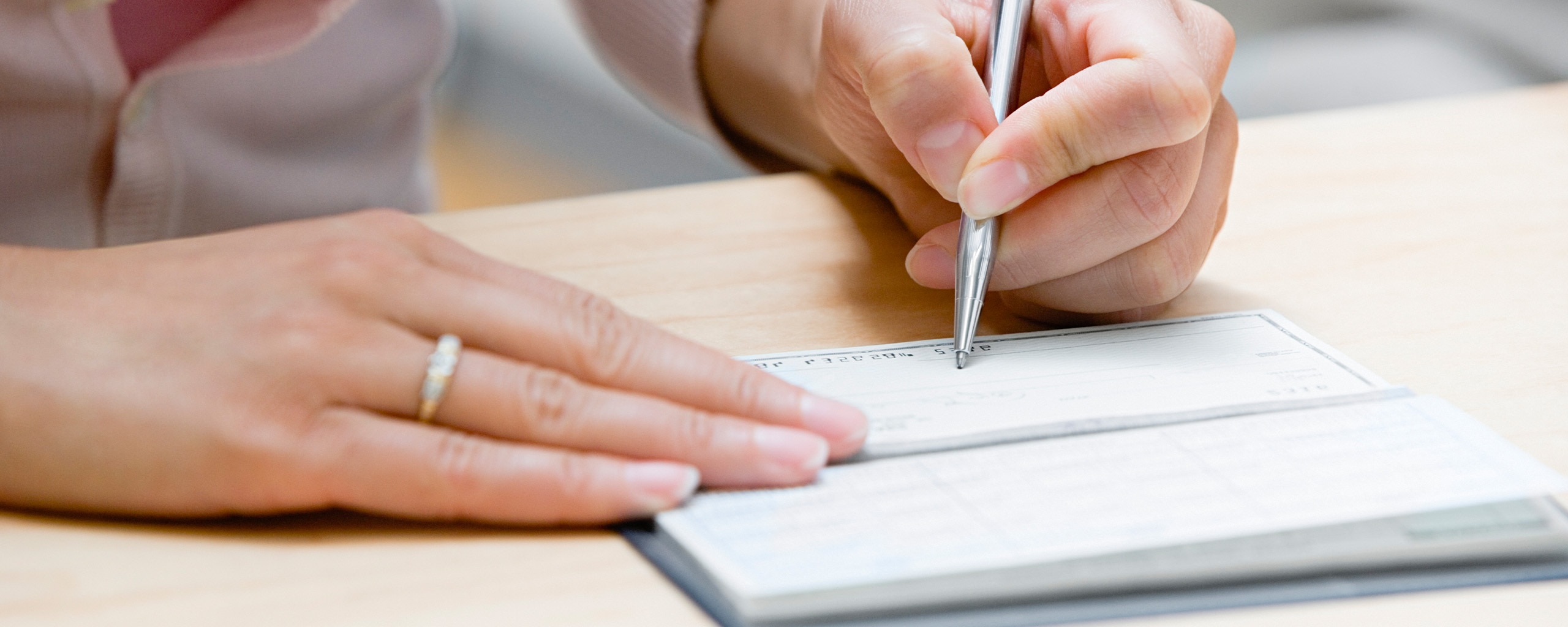 Person writing a check.
