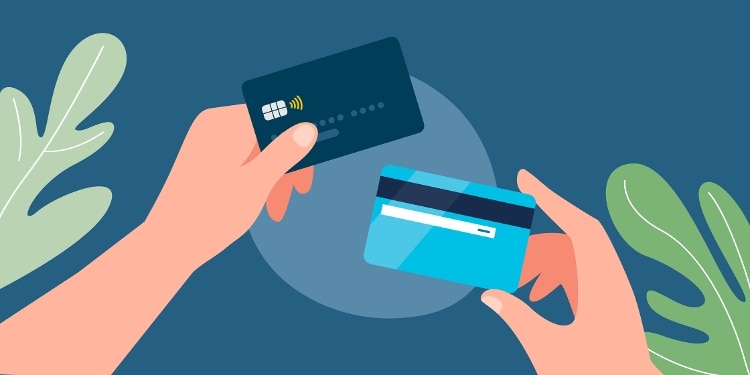 A graphic of hands holding two Capital One cards.