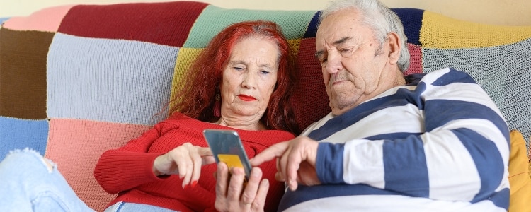 Two people check the security of their banking app on their phone.