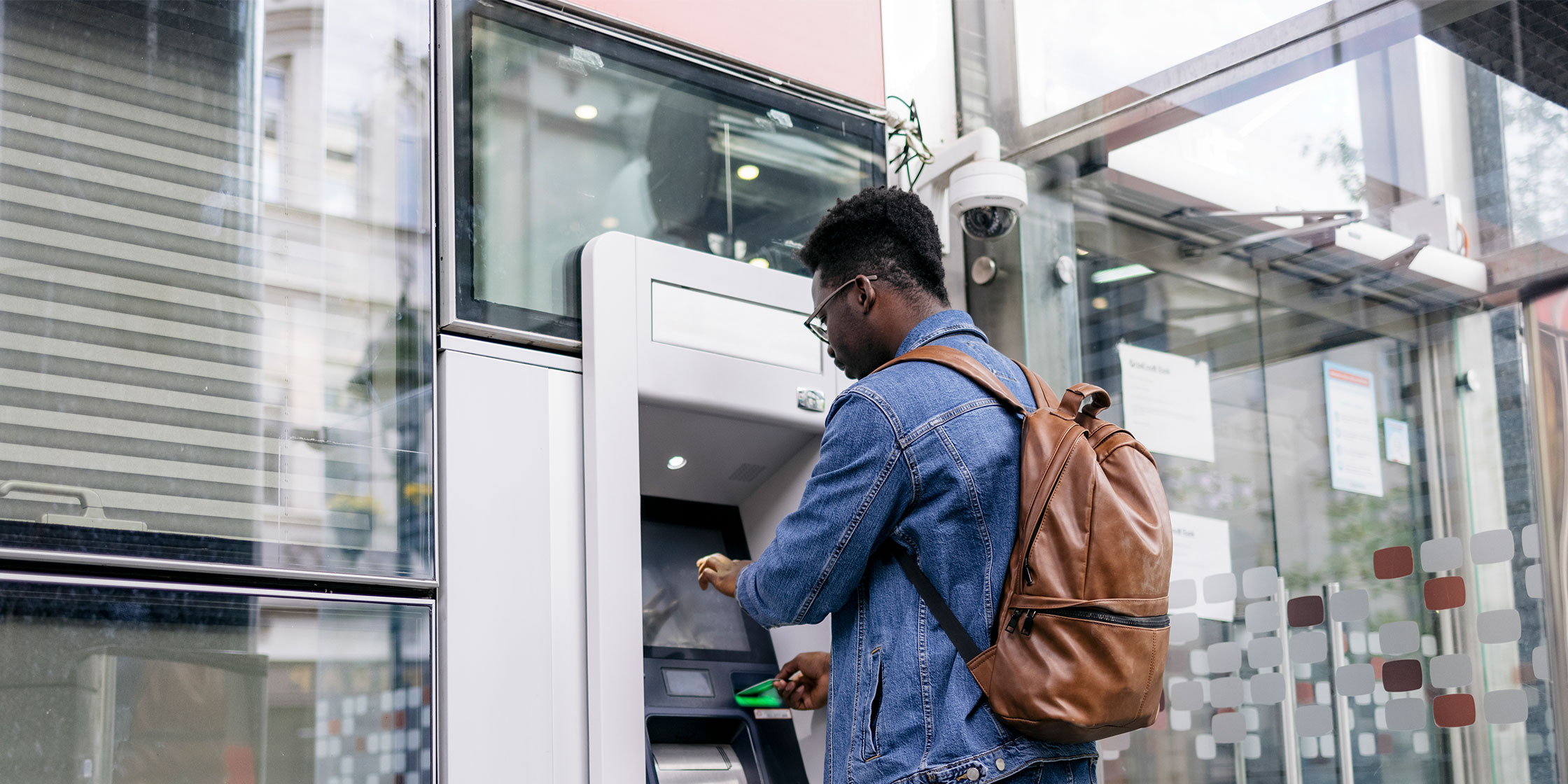 A man gets a cash advance at an ATM.