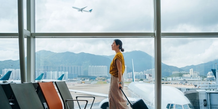 A person walks through an airport before a trip booked with their airline miles.