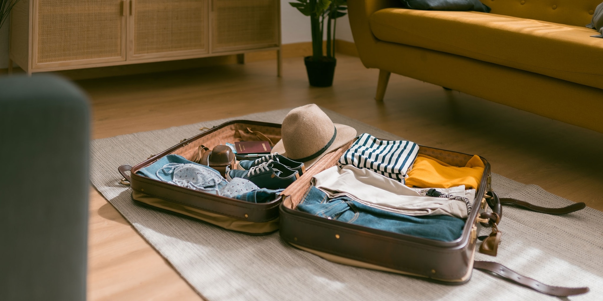A packed suitcase lying open on the floor.