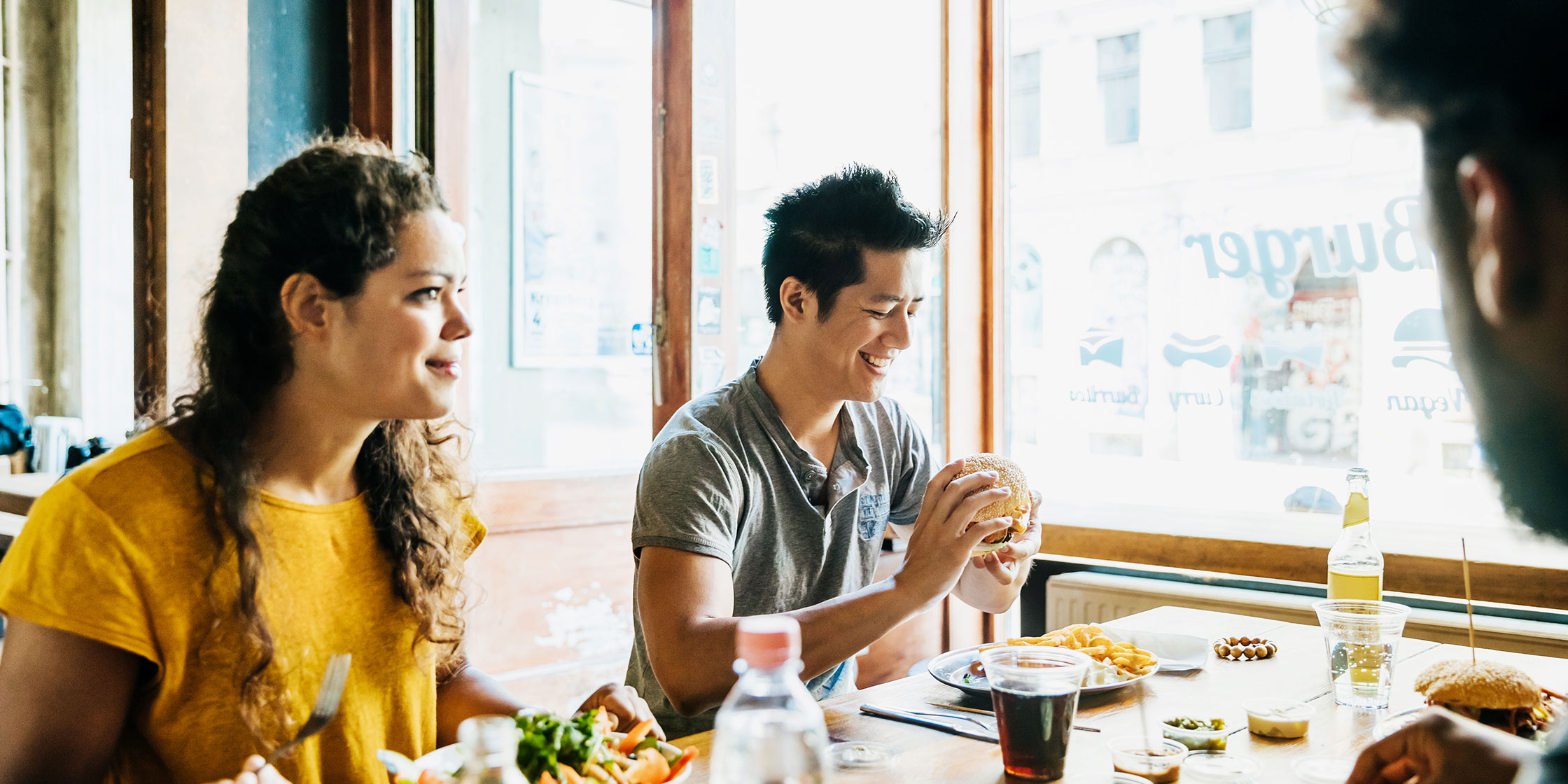 Several people enjoy a meal at a restaurant and receive dining rewards.