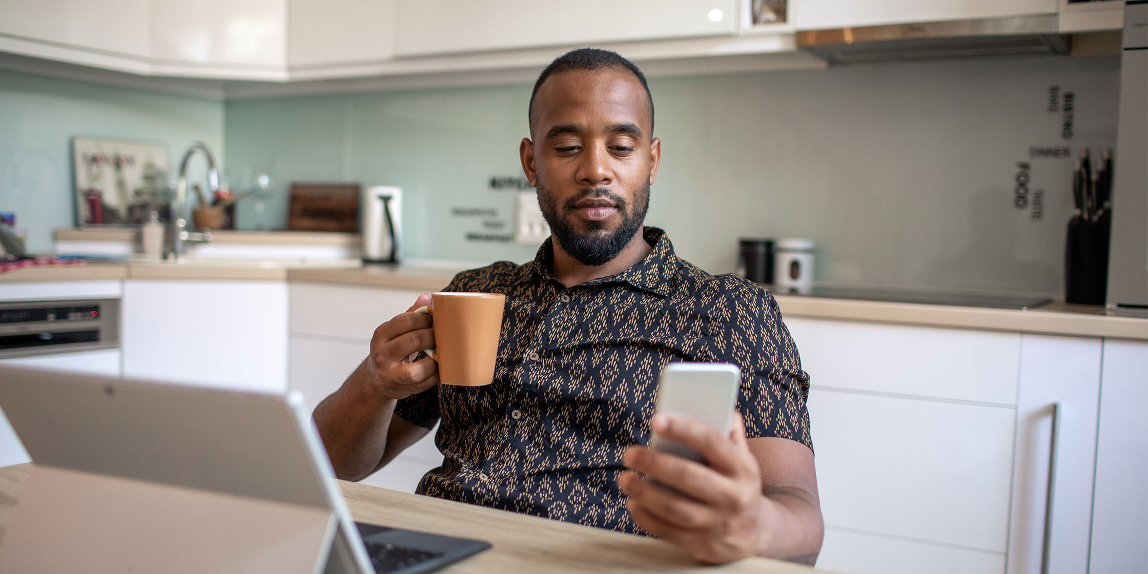 A person checks their phone to compare credit cards before applying.